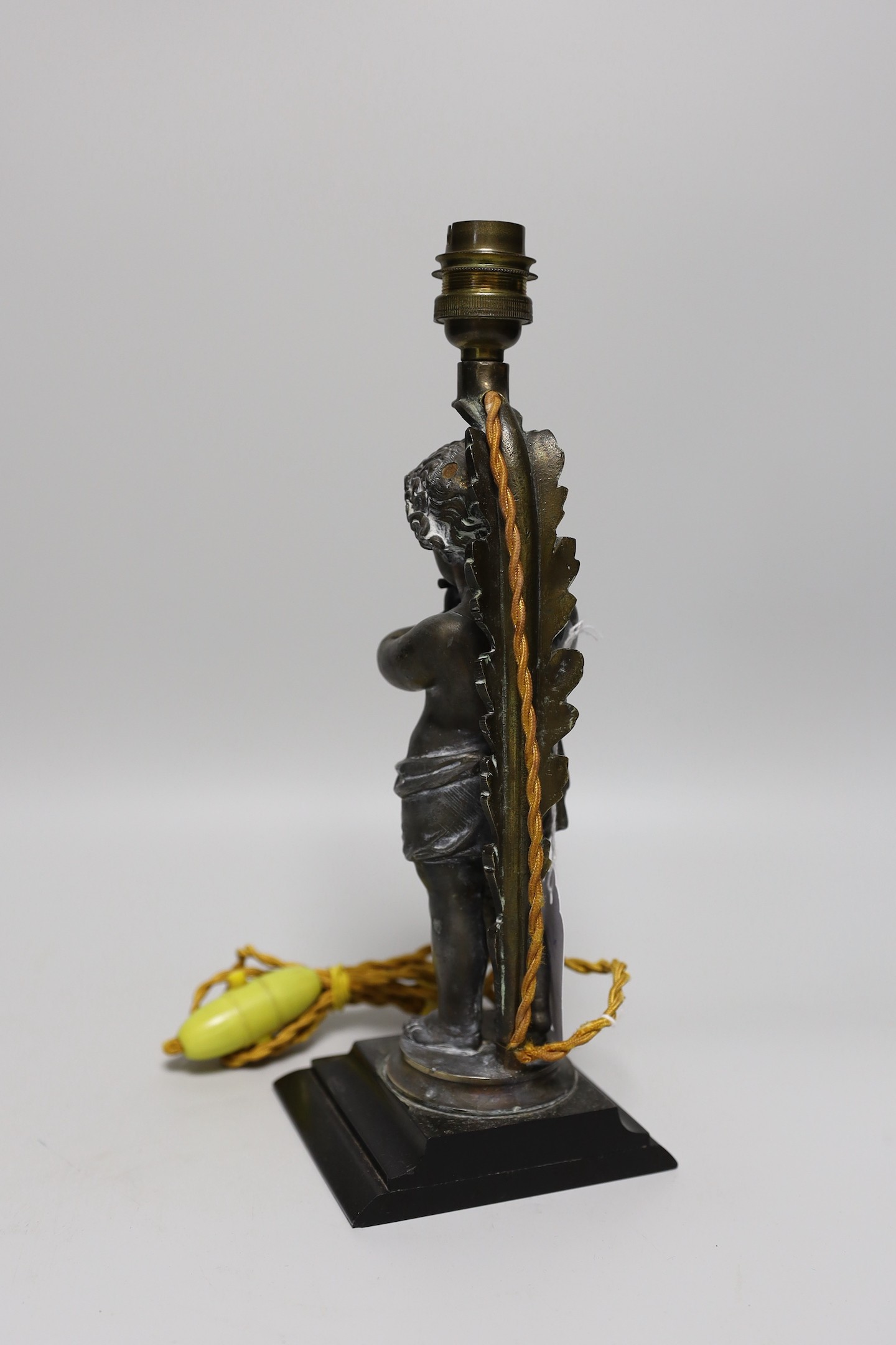 A metal musical putti lamp base, 30cms high